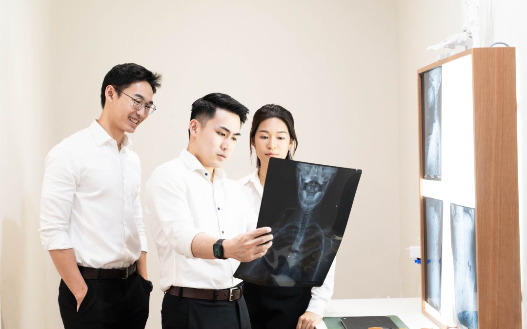 "Gonstead chiropractors in Taman Melawati, Ampang analyzing an X-ray for precise diagnosis and personalized treatment planning."