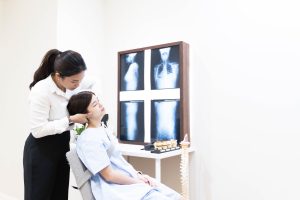 Our Gonstead Chiropractor adjusting a patient's neck on the cervical chair at Elevate Chiropractic.